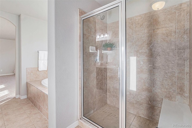 bathroom with tile patterned floors and separate shower and tub