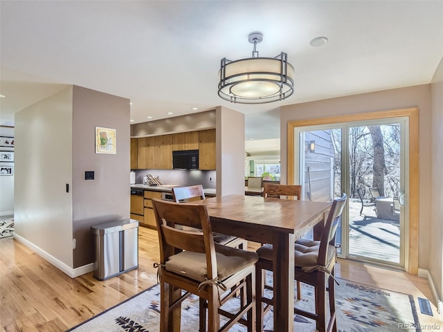 1540 W Briarwood Ave, Littleton, CO 80120 - dining space featuring light wood-style floors and baseboards