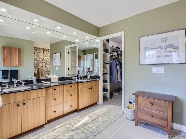 1540 W Briarwood Ave, Littleton, CO 80120 - bathroom with recessed lighting, double vanity, tile patterned flooring, a spacious closet, and baseboards