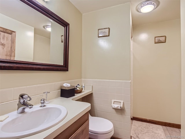 1540 W Briarwood Ave, Littleton, CO 80120 - bathroom with tile walls, toilet, vanity, tile patterned floors, and a wainscoted wall