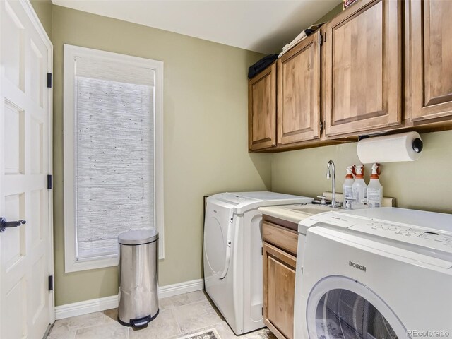 1540 W Briarwood Ave, Littleton, CO 80120 - washroom featuring cabinet space, separate washer and dryer, and baseboards