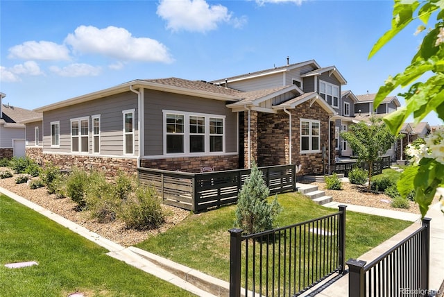 15501 E 112th Ave Unit 6F, Commerce City, CO 80022 - view of front of property featuring stone siding and a shingled roof