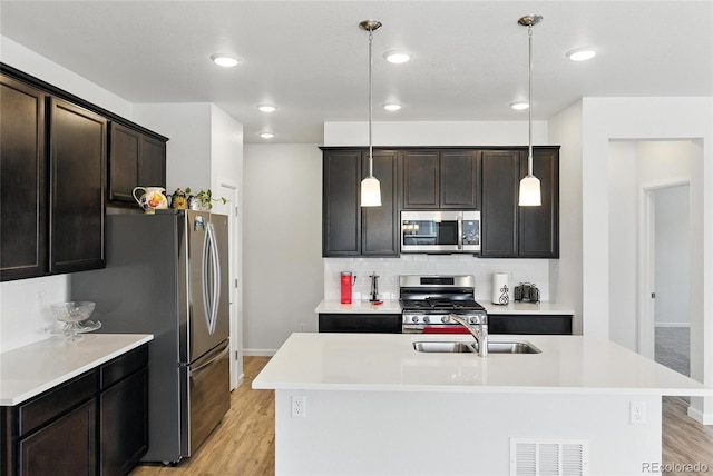 15501 E 112th Ave Unit 6F, Commerce City, CO 80022 - kitchen featuring appliances with stainless steel finishes, light countertops, light wood finished floors, tasteful backsplash, and recessed lighting