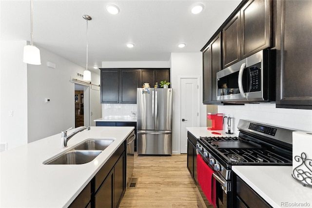 15501 E 112th Ave Unit 6F, Commerce City, CO 80022 - kitchen featuring stainless steel appliances, light countertops, tasteful backsplash, light wood-style flooring, and recessed lighting