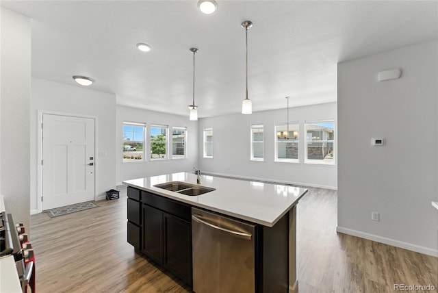 15501 E 112th Ave Unit 6F, Commerce City, CO 80022 - kitchen with stainless steel appliances, light countertops, light wood-type flooring, and a kitchen island with sink