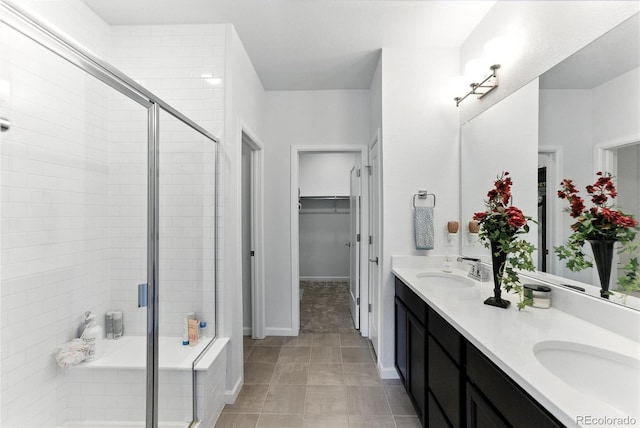 15501 E 112th Ave Unit 6F, Commerce City, CO 80022 - full bathroom featuring a stall shower, double vanity, and a walk in closet