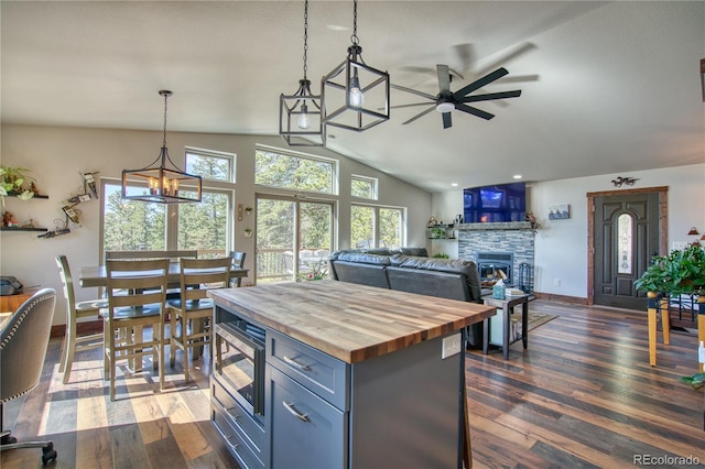 61 Country Sky Ln, Estes Park, CO 80517 - kitchen featuring butcher block countertops, ceiling fan, lofted ceiling, decorative light fixtures, and a fireplace