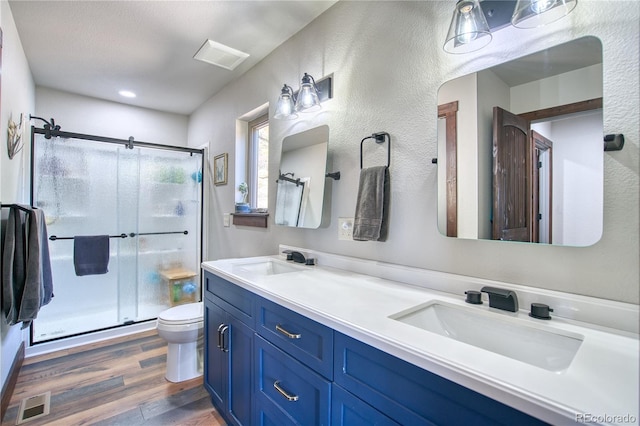 61 Country Sky Ln, Estes Park, CO 80517 - bathroom featuring wood finished floors, double vanity, and a shower stall