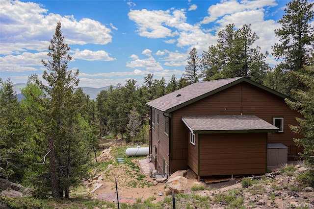 61 Country Sky Ln, Estes Park, CO 80517 - view of side of property with roof with shingles, a mountain view, and a wooded view