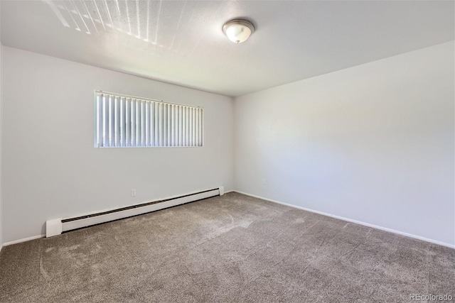 carpeted empty room with a baseboard heating unit