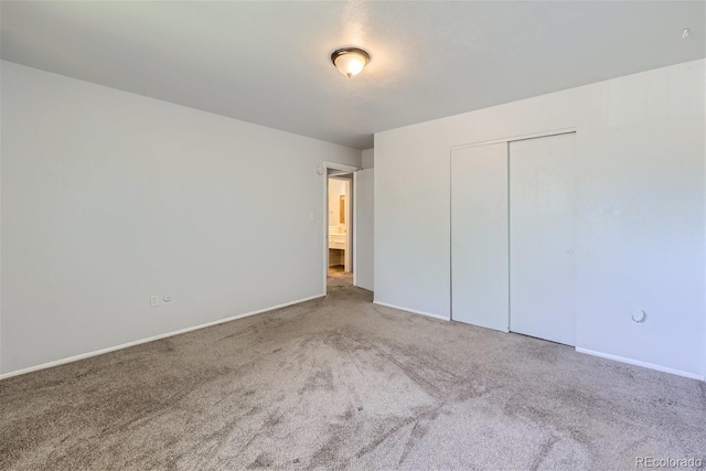 unfurnished bedroom featuring carpet and a closet