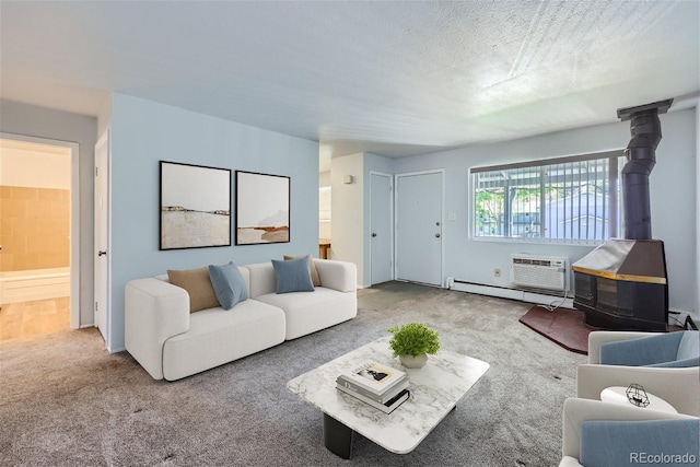 carpeted living room with a baseboard heating unit, a textured ceiling, a wall unit AC, and a wood stove