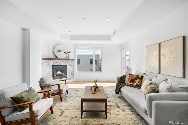 3301 Arapahoe Ave Unit 411, Boulder, CO 80303 - living area with wood finished floors, a tiled fireplace, recessed lighting, and a raised ceiling