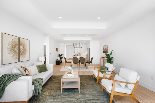3301 Arapahoe Ave Unit 411, Boulder, CO 80303 - living area featuring recessed lighting, a chandelier, wood finished floors, and a raised ceiling