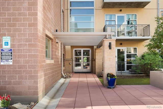 3301 Arapahoe Ave Unit 411, Boulder, CO 80303 - doorway to property featuring a balcony, french doors, and stucco siding