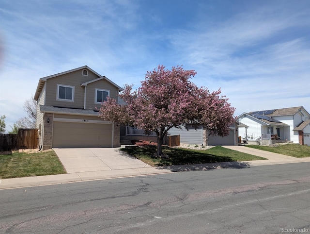 4483 S Fundy St, Centennial, CO 80015 - view of front of property featuring concrete driveway, an attached garage, and brick siding