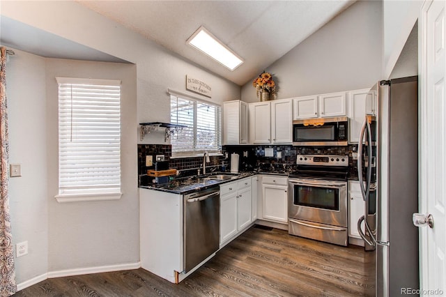 4483 S Fundy St, Centennial, CO 80015 - kitchen with stainless steel appliances, tasteful backsplash, white cabinetry, vaulted ceiling, and dark wood-style floors