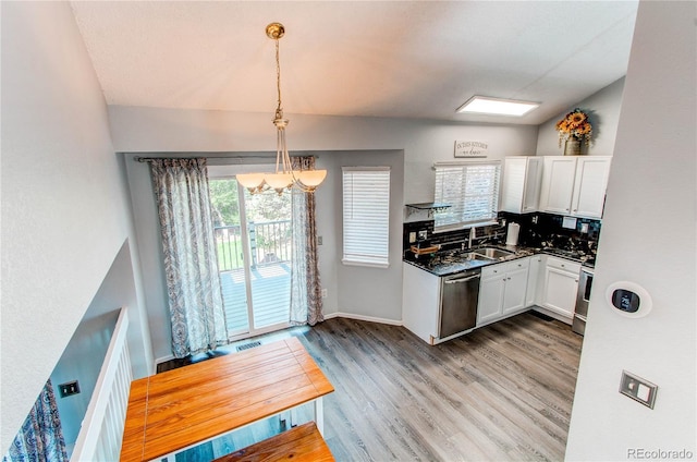 4483 S Fundy St, Centennial, CO 80015 - kitchen with stainless steel dishwasher, a chandelier, white cabinets, dark countertops, and light wood-style flooring