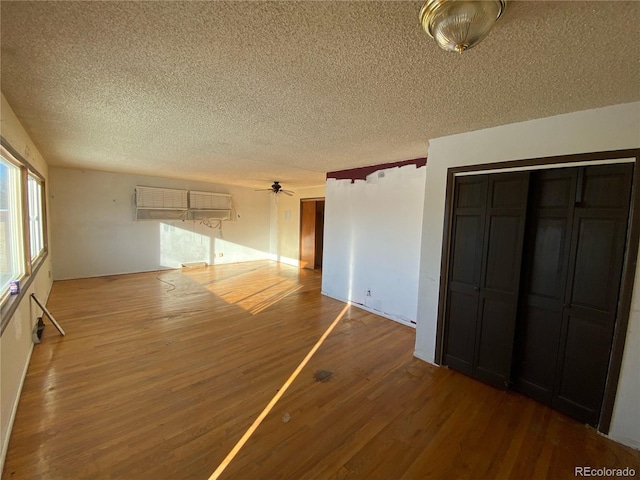 unfurnished room featuring ceiling fan, a textured ceiling, and hardwood / wood-style flooring