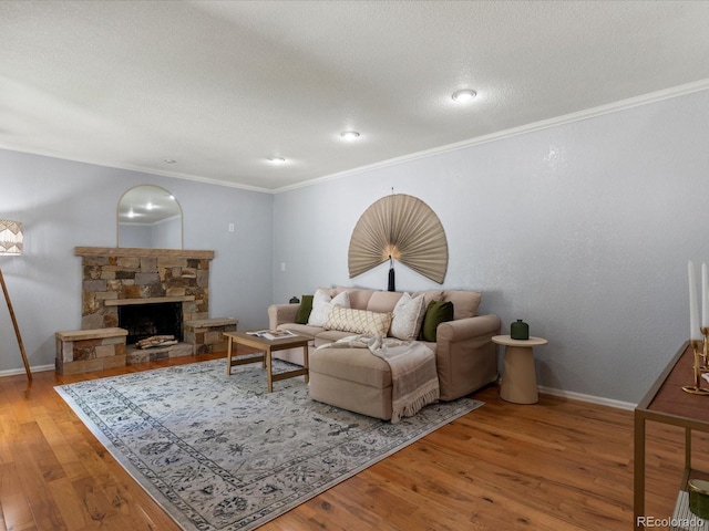 9696 E Kansas Cir Unit 2, Denver, CO 80247 - living room featuring wood finished floors, ornamental molding, and a stone fireplace