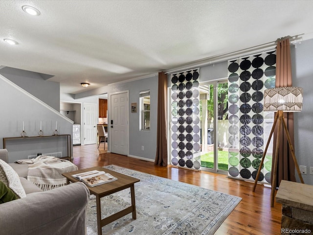 9696 E Kansas Cir Unit 2, Denver, CO 80247 - living room with a textured ceiling, wood finished floors, washer / clothes dryer, and stairs