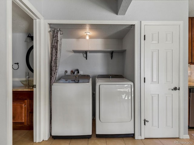 9696 E Kansas Cir Unit 2, Denver, CO 80247 - laundry room featuring washing machine and dryer and light tile patterned floors