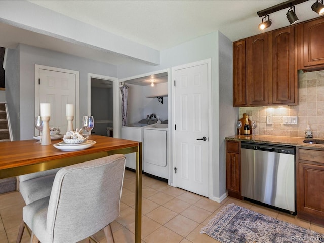 9696 E Kansas Cir Unit 2, Denver, CO 80247 - kitchen featuring stainless steel dishwasher, separate washer and dryer, light tile patterned floors, decorative backsplash, and stone countertops