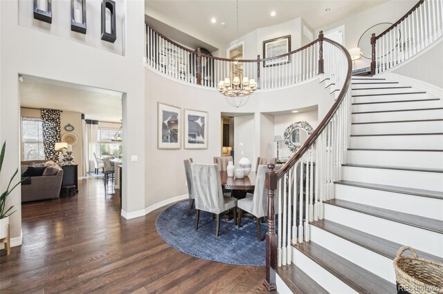25548 E Fair Dr, Aurora, CO 80016 - dining space featuring a chandelier, wood finished floors, stairway, a high ceiling, and recessed lighting
