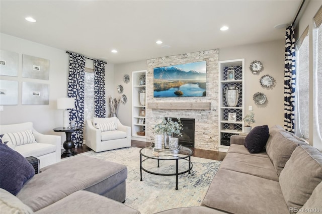 25548 E Fair Dr, Aurora, CO 80016 - living room with wood finished floors, built in shelves, recessed lighting, and a stone fireplace