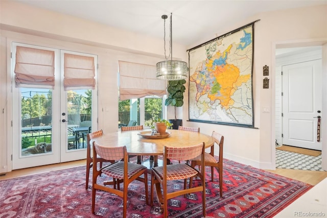 1455 Flowers Ct, Erie, CO 80516 - dining area featuring french doors, baseboards, and wood finished floors