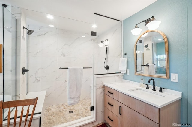 1455 Flowers Ct, Erie, CO 80516 - bathroom featuring recessed lighting, a marble finish shower, and vanity