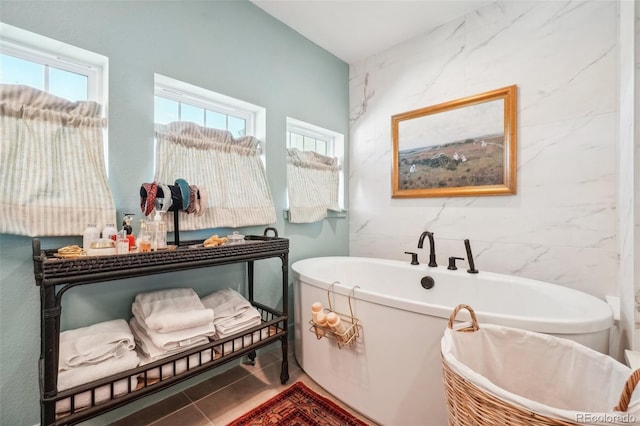 1455 Flowers Ct, Erie, CO 80516 - bathroom with tile walls and a freestanding bath