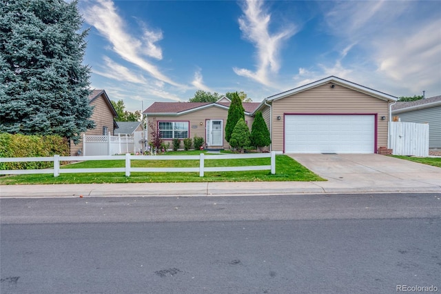 ranch-style home featuring a garage and a front lawn