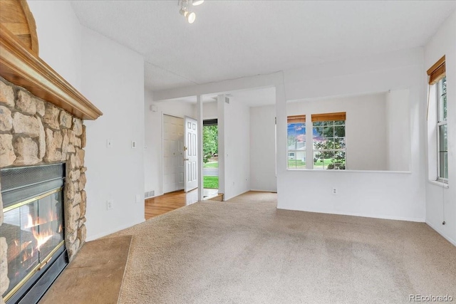 unfurnished living room featuring a fireplace and light carpet