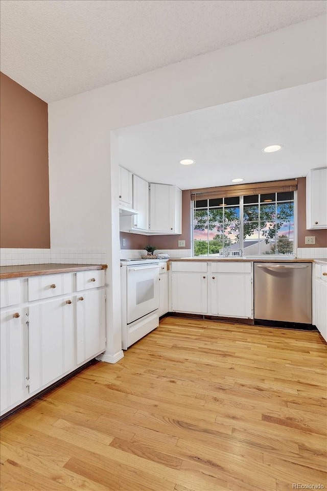 kitchen with white cabinets, light hardwood / wood-style flooring, tile countertops, white range with electric stovetop, and stainless steel dishwasher