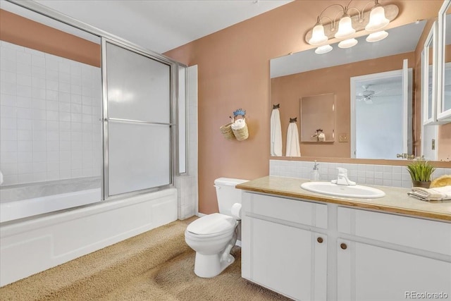 full bathroom with vanity, toilet, bath / shower combo with glass door, and tasteful backsplash