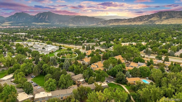 aerial view at dusk featuring a mountain view