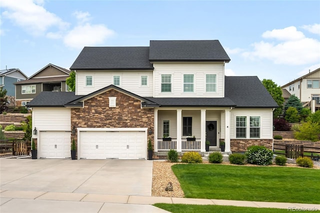 23421 E Rockinghorse Pkwy, Aurora, CO 80016 - view of front facade featuring covered porch, driveway, a front yard, an attached garage, and stone siding