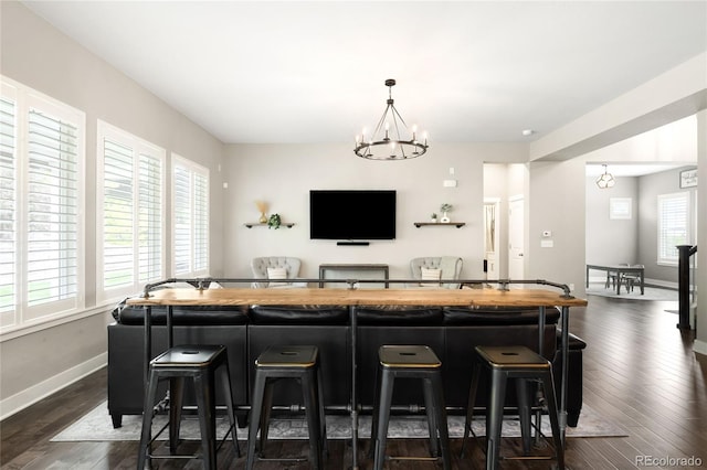 23421 E Rockinghorse Pkwy, Aurora, CO 80016 - bar area featuring a chandelier, dark wood finished floors, and hanging light fixtures