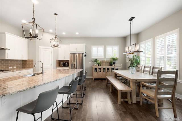 23421 E Rockinghorse Pkwy, Aurora, CO 80016 - kitchen with a chandelier, recessed lighting, tasteful backsplash, white cabinets, and dark wood finished floors
