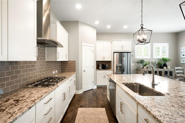 23421 E Rockinghorse Pkwy, Aurora, CO 80016 - kitchen featuring stainless steel appliances, wall chimney exhaust hood, dark wood-style floors, white cabinetry, and pendant lighting