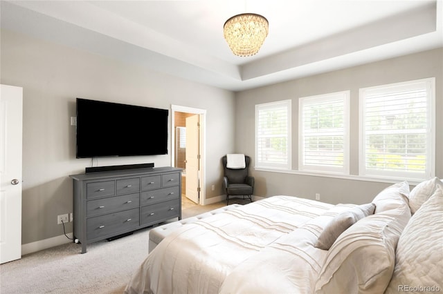 23421 E Rockinghorse Pkwy, Aurora, CO 80016 - bedroom featuring light carpet, a chandelier, a tray ceiling, and connected bathroom
