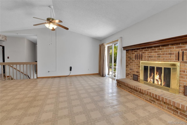 unfurnished living room featuring vaulted ceiling, baseboards, a fireplace, a textured ceiling, and ceiling fan