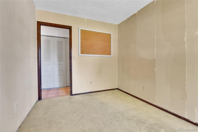 unfurnished bedroom with carpet and a textured ceiling