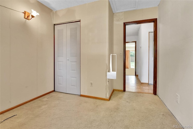 unfurnished bedroom with carpet floors, a closet, and baseboards