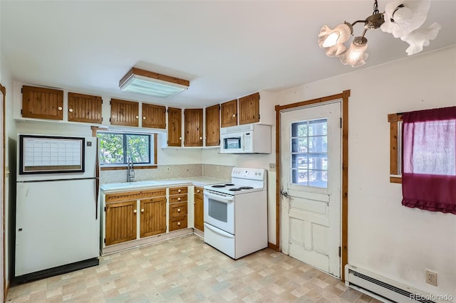 kitchen featuring baseboard heating, sink, and white appliances