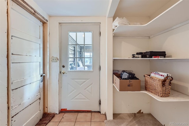 doorway with light tile patterned floors