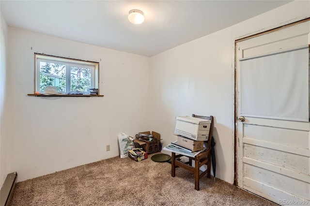 misc room featuring carpet floors and a baseboard heating unit