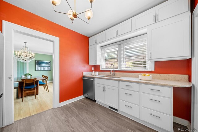 kitchen featuring sink, an inviting chandelier, white cabinetry, decorative light fixtures, and dishwasher