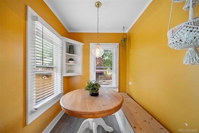 dining room with crown molding and hardwood / wood-style flooring